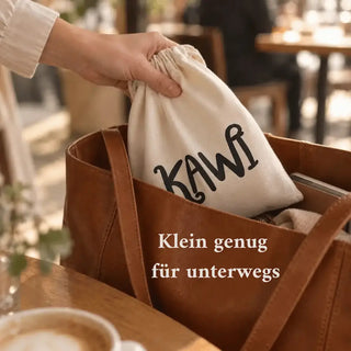 KAWI Senso im Baumwollbeutel mit KAWI-Logo wird im Café in eine Ledertasche gesteckt